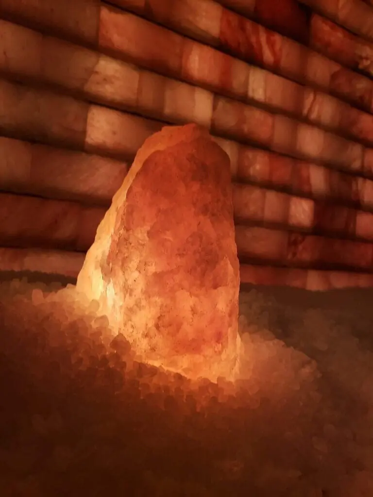 A Himalayan salt lamp glowing warm