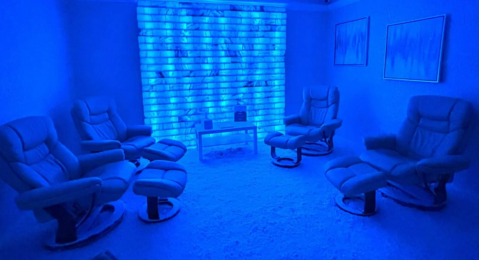 The adult salt room, recliners facing a lit salt wall